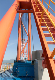 Mr. H of Sumitomo Heavy Industries stands on the counterweight that balances the jib. It is reached by climbing up a set of stairs from the cabin.