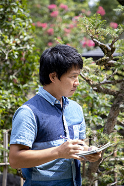 Mr. Tsuboi taking notes in the garden